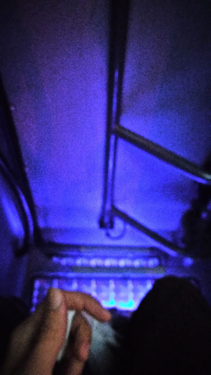 The stairwell of the bus, lit blue