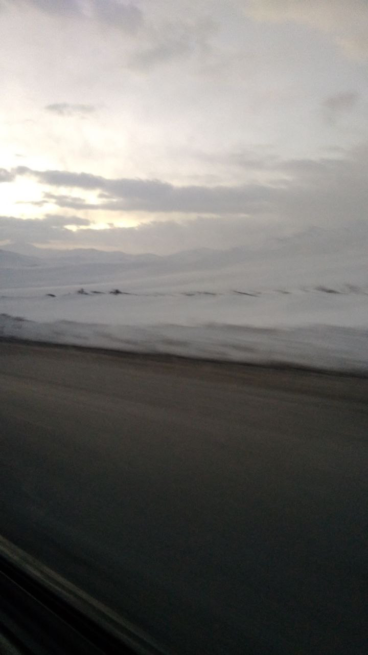 The road and snowfields blurring past