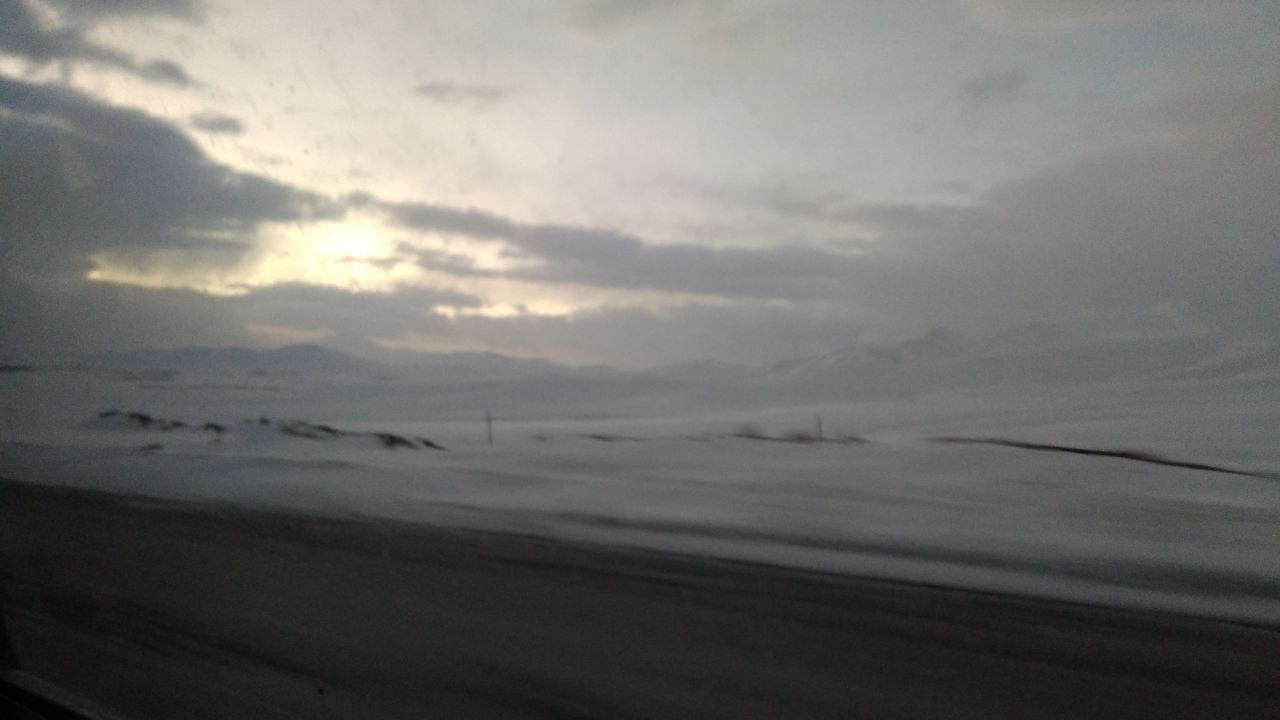 Sun breaking through cloud over the snow