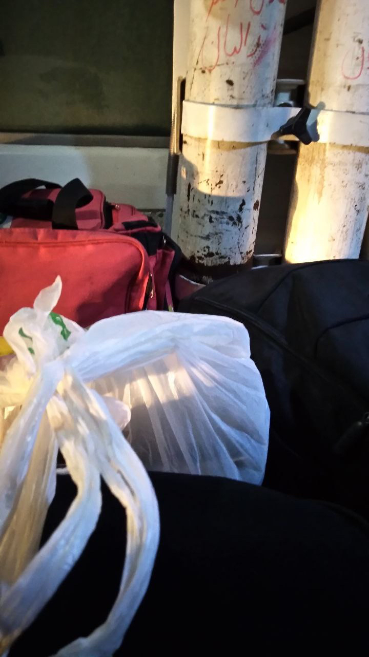 Bags piled in the luggage bay next to me